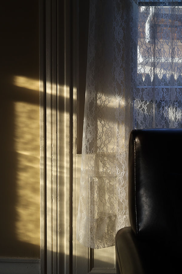 Dramatic Shadows, Lace Curtains, Window, and Edge of Armchair Back.